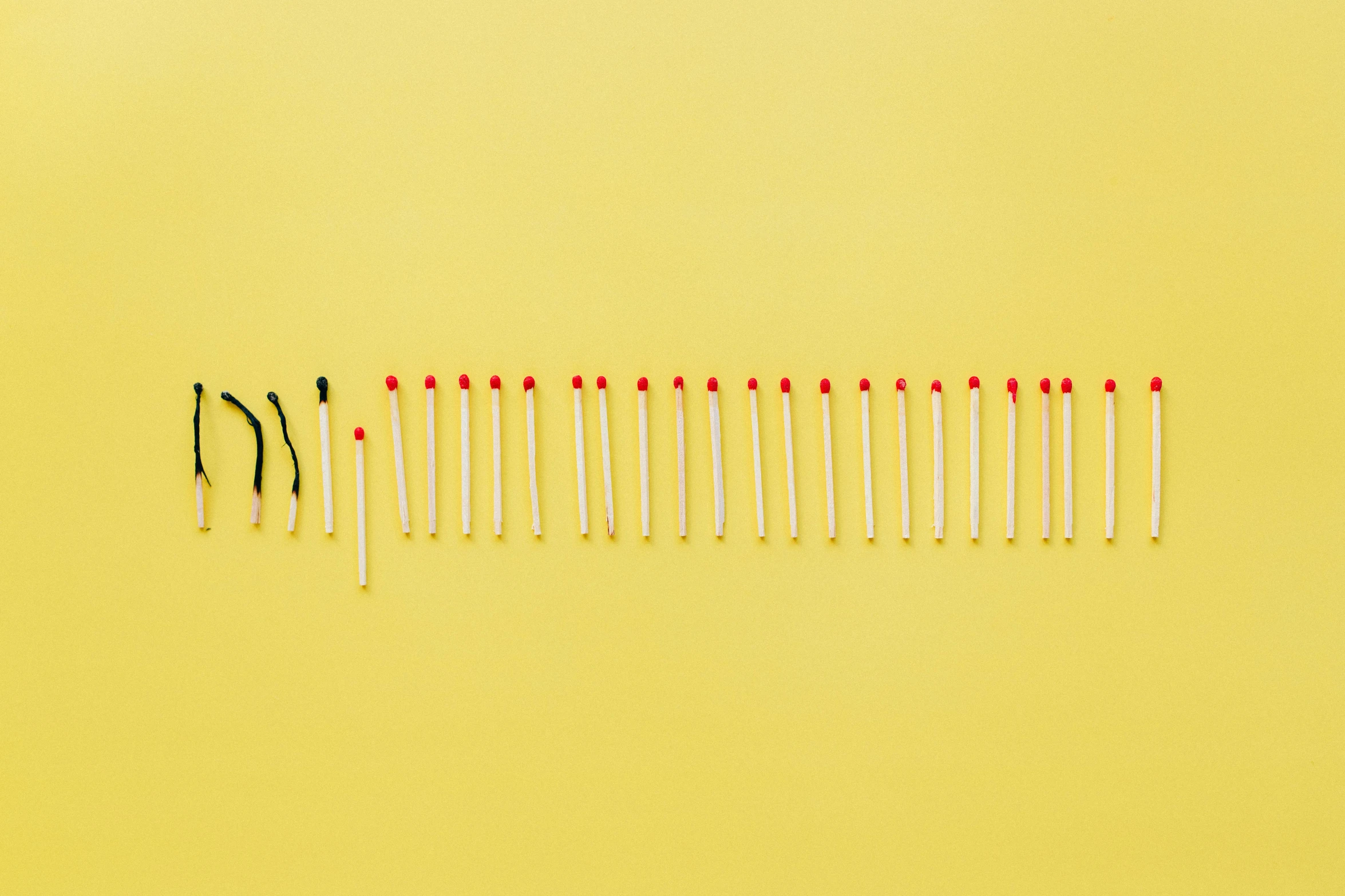 a row of matches on a yellow background, by Attila Meszlenyi, minimalism, pregnancy, body breaking apart, capacitors, knolling