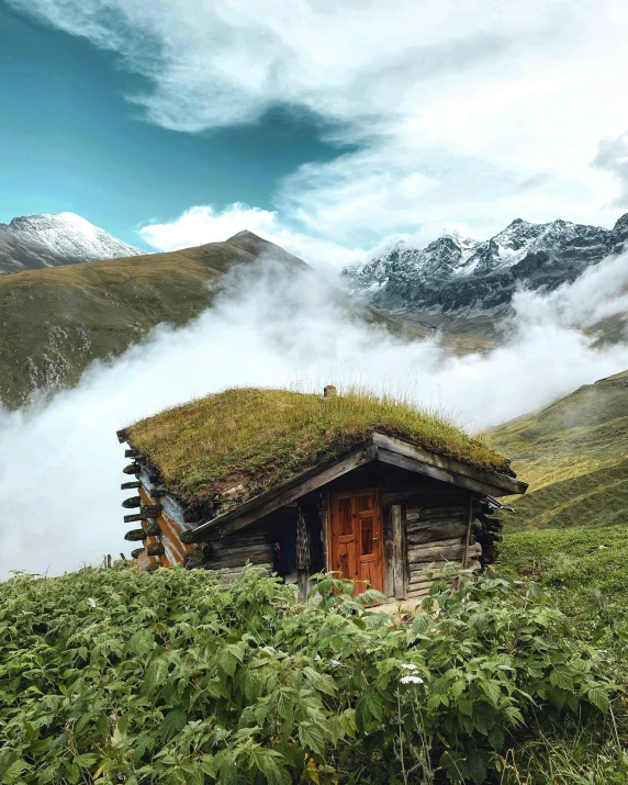 a small cabin sitting on top of a lush green hillside, a matte painting, pexels contest winner, sitting in a fluffy cloud, 9gag, conde nast traveler photo, turf roof