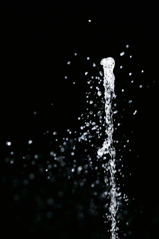 a close up of water pouring from a faucet, by Adam Chmielowski, conceptual art, ffffound, on black paper, sparkling, large tall