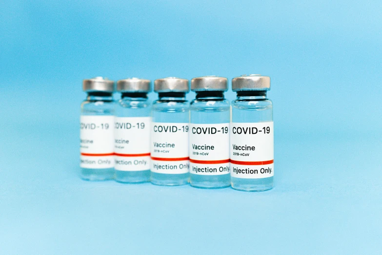 three vials filled with vaccines on a blue background, a picture, shutterstock, instagram post, covid, 6 pack, grey