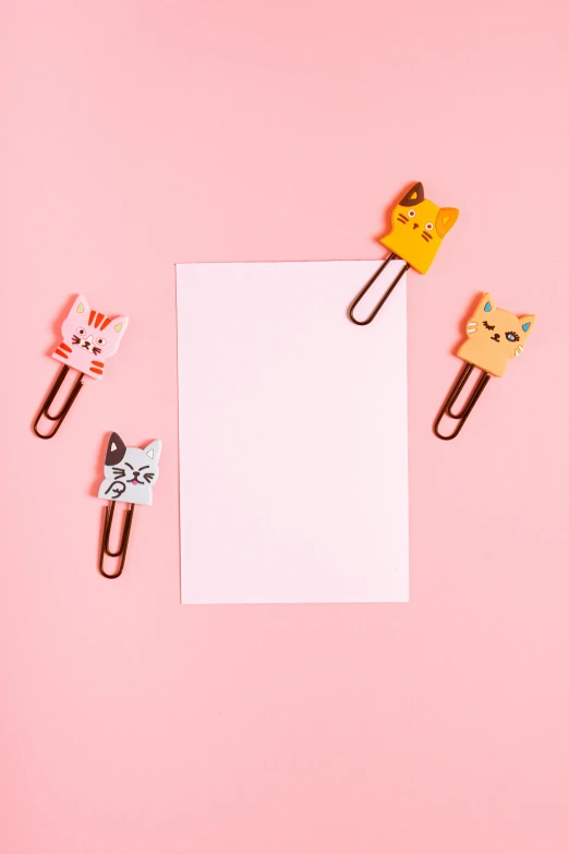 a piece of paper sitting on top of a pink surface, cute cats, clamp style, full product shot, detailed product image