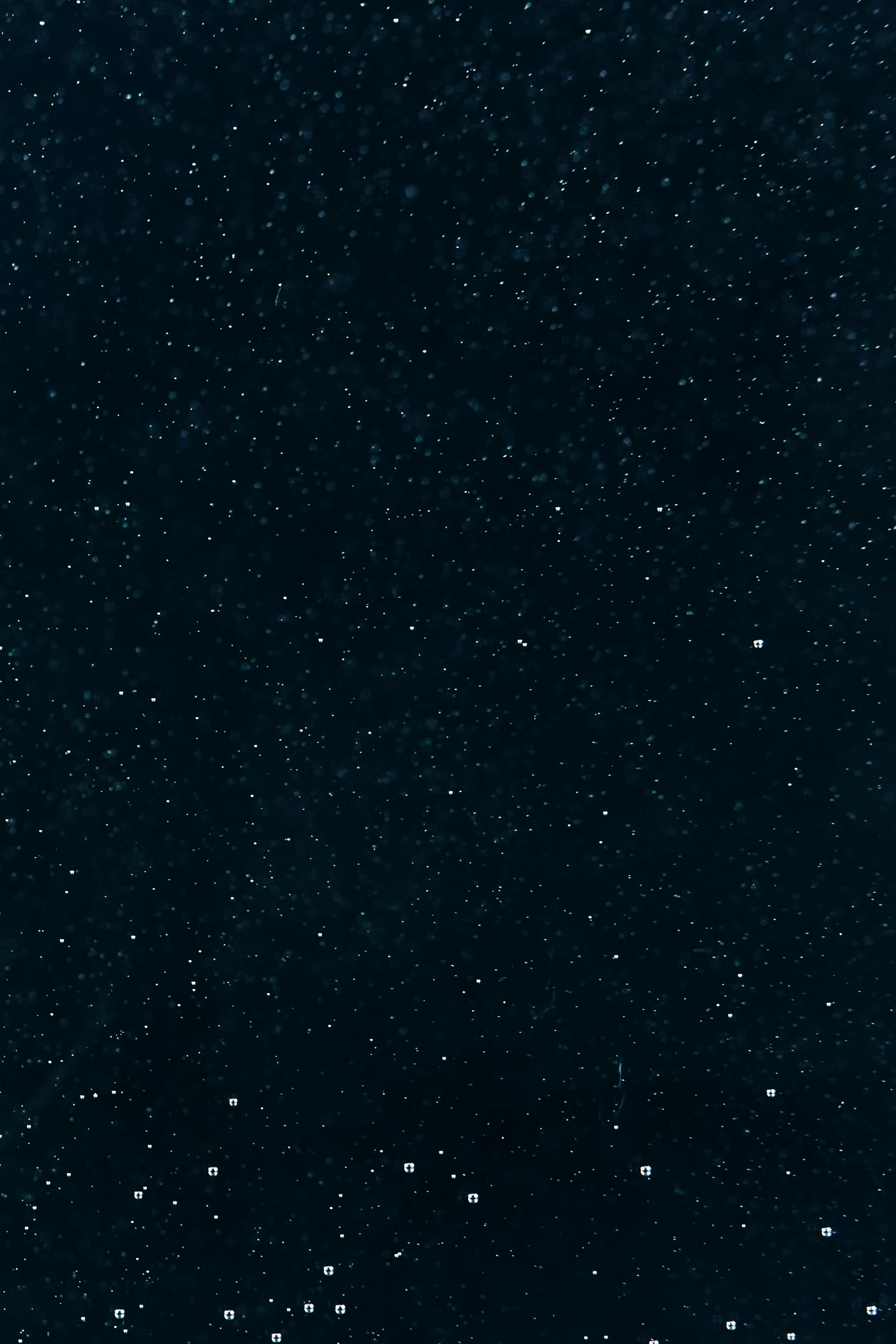 a group of people standing on top of a snow covered slope, an album cover, by Vija Celmins, trending on unsplash, black night sky, background image, tiny stars, background(solid)