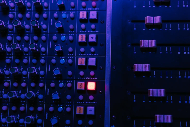 a close up of a bunch of electronic equipment, an album cover, inspired by Elsa Bleda, unsplash, process art, cool purple slate blue lighting, softly glowing control panels, barely lit warm violet red light, knobs