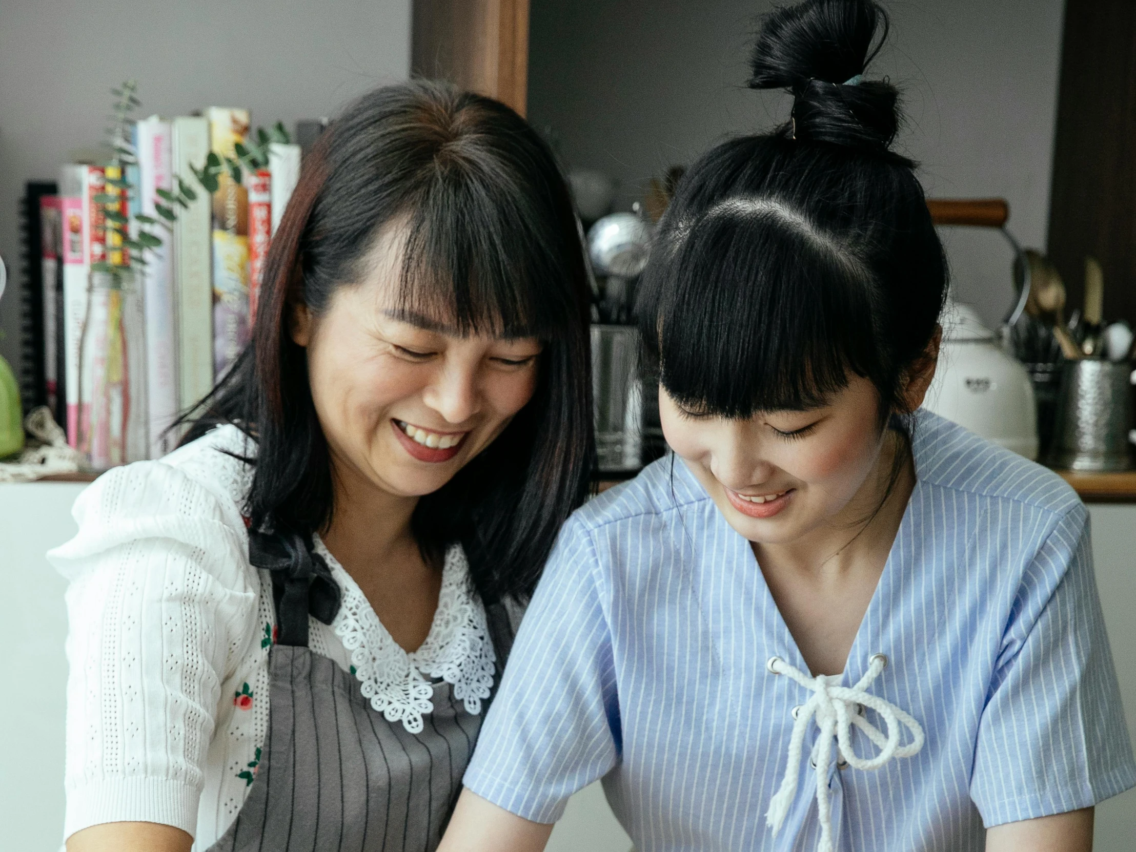 a couple of women standing next to each other, inspired by Yukimasa Ida, pexels contest winner, mingei, on kitchen table, profile image, japanese collection product, seifuku