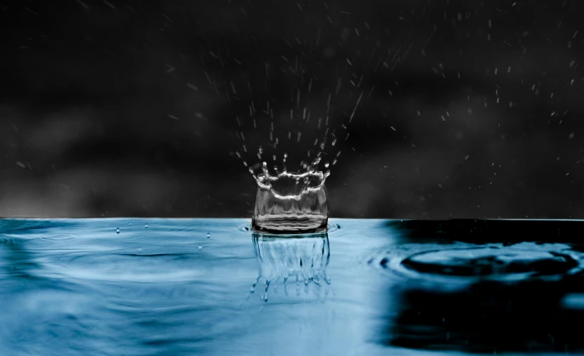 a water drop with a crown on top of it, unsplash, glass rain, thumbnail, rippling electromagnetic, falling rain