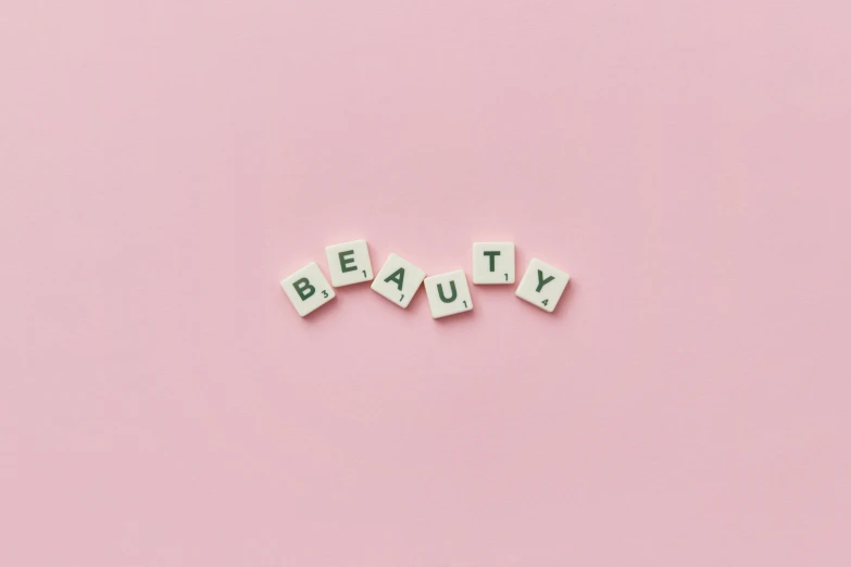 the word beauty spelled with scrabbles on a pink background, by Olivia Peguero, trending on pexels, aestheticism, on a pale background, y2k, beautiful image ever created, set on singaporean aesthetic