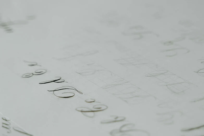 a close up of a piece of paper with writing on it, grey, calligraphy formula, low - angle shot, thumbnail