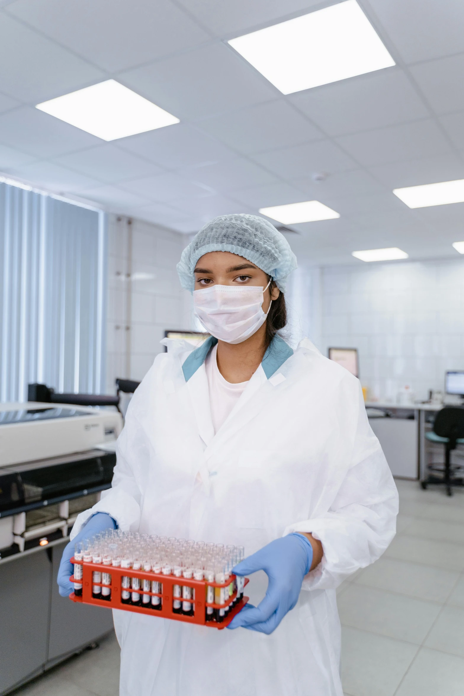 a woman in a lab holding a box of blood, shutterstock, 15081959 21121991 01012000 4k, carrying a tray, malaysian, gif