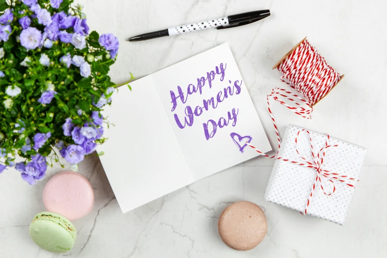 a card with the words happy women's day written on it, pixabay, hurufiyya, on a white table, background image, packshot, indoor shot