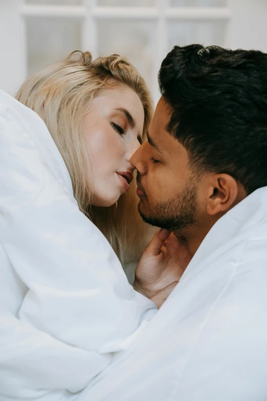 a man kissing a woman under a blanket, trending on pexels, wearing a white button up shirt, wearing a robe, non binary model, mixed race