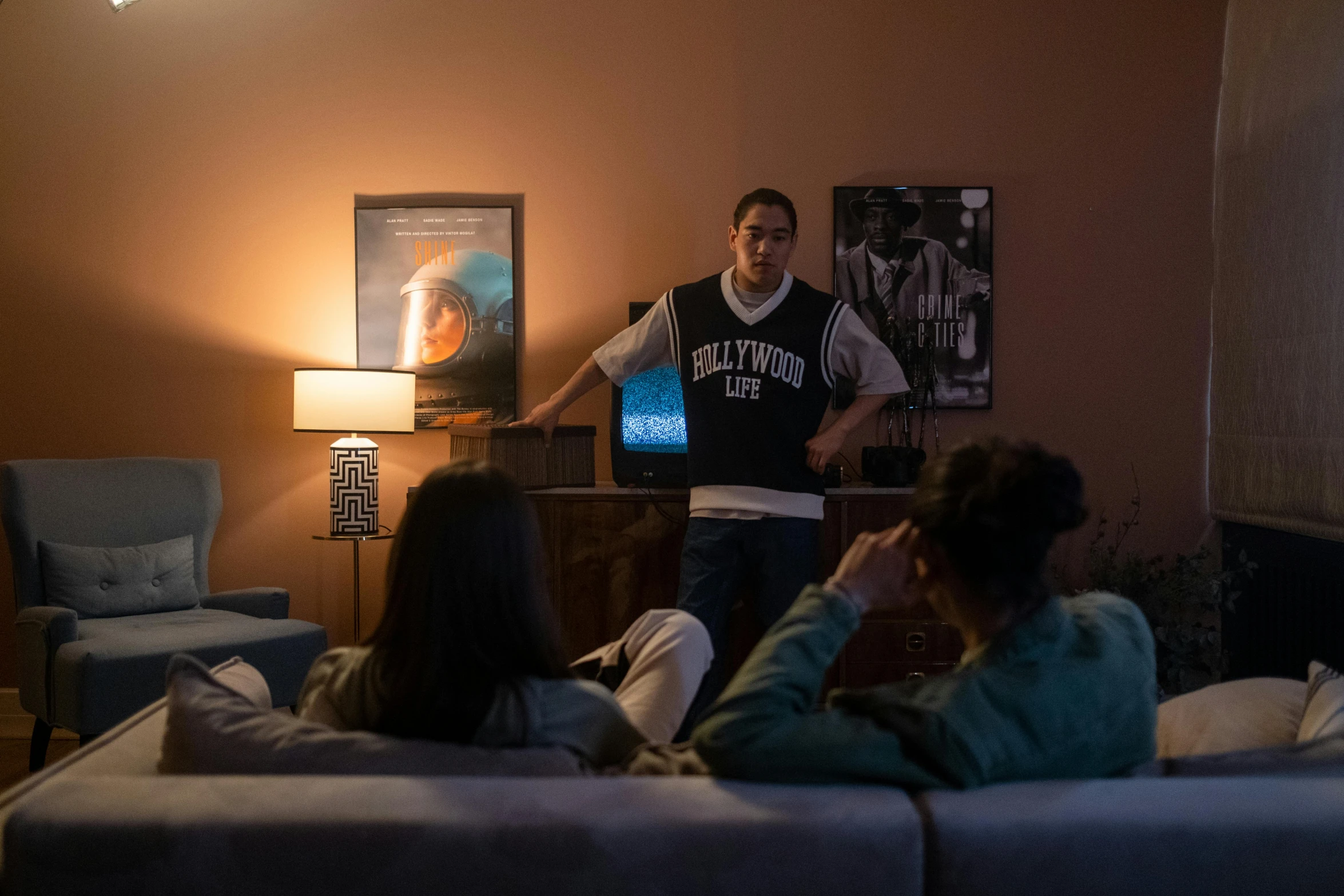 a group of people sitting on a couch in a living room, a hologram, serial art, tessa thompson, [ theatrical ]