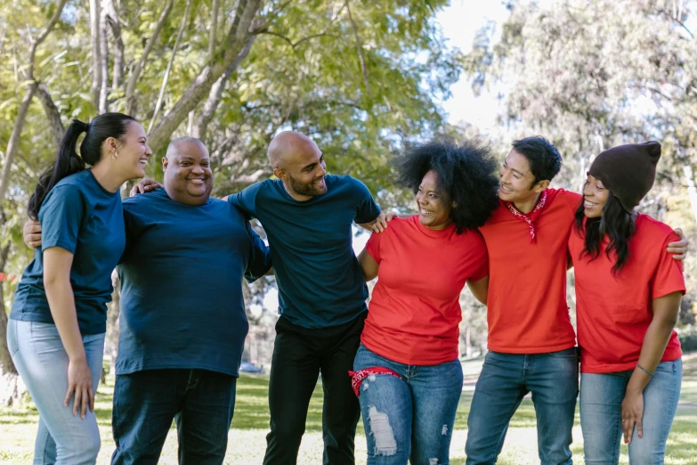 a group of people standing next to each other in a park, pexels, red shirt brown pants, plus-sized, diverse ages, black