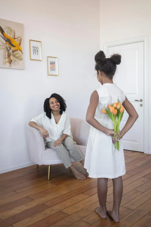 a woman in a white dress standing next to a woman in a white dress, inspired by Pieter de Hooch, pexels contest winner, afro made of flowers, sitting in her room, family friendly, product introduction photo