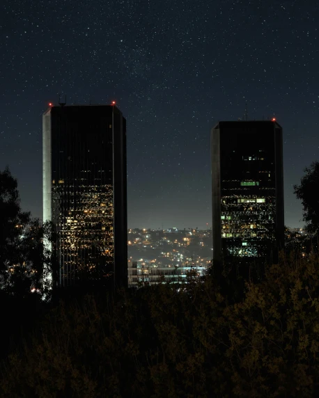 a couple of tall buildings sitting next to each other, a matte painting, pexels contest winner, brutalism, set in observatory at night, calarts, top of the hill, high picture quality