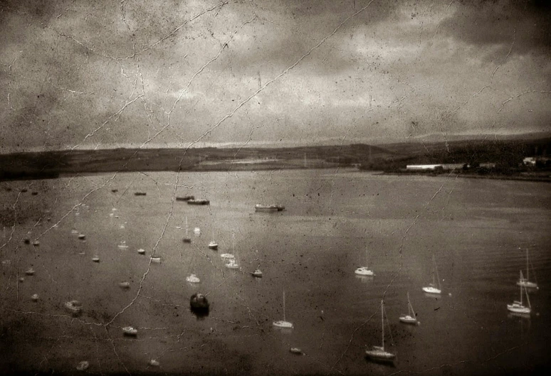 a large body of water filled with lots of boats, a black and white photo, inspired by Antoine Verney-Carron, flickr, tonalism, steampunk!!!! grainy texture, cornwall, detailed medium format photo, old photo width 768