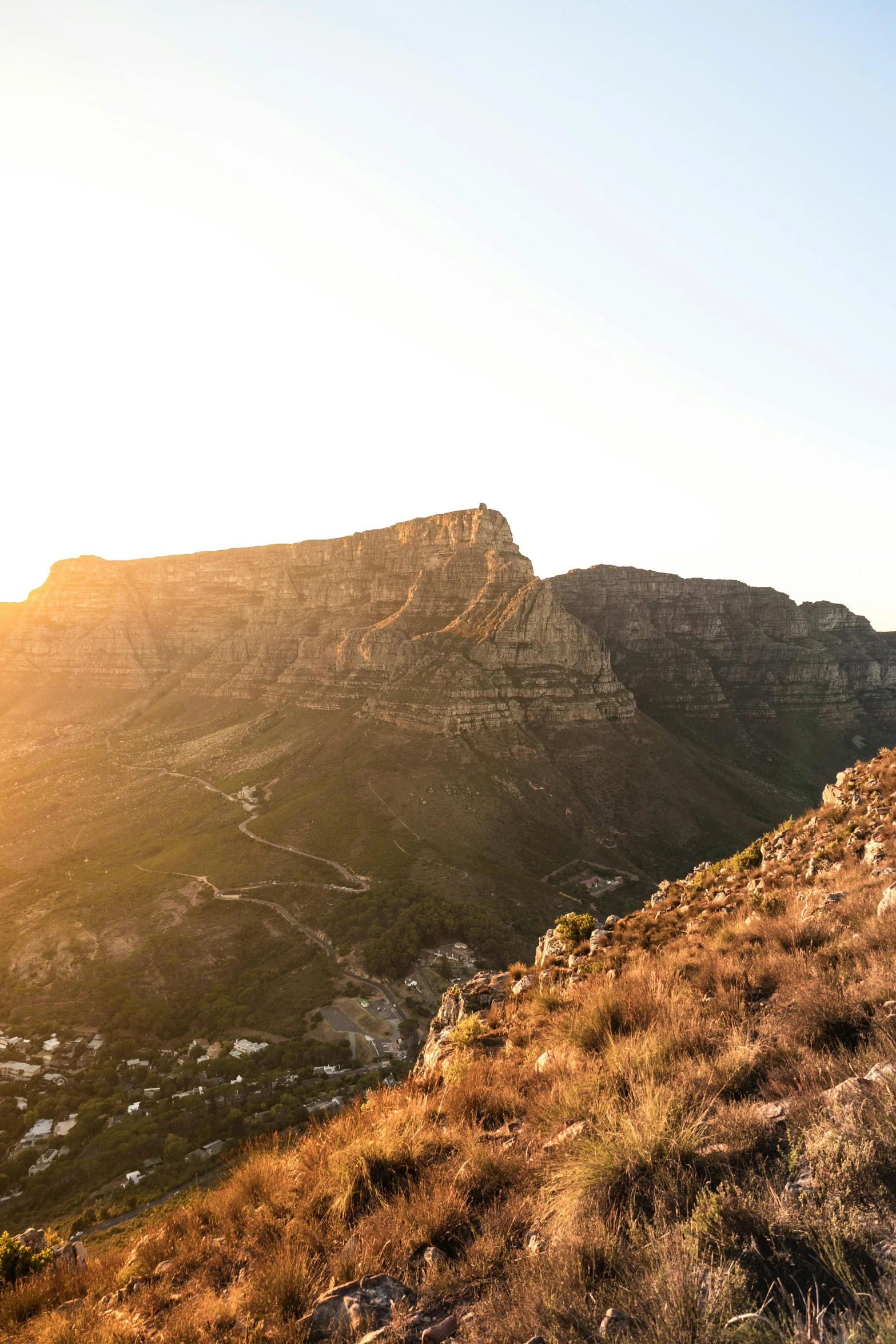 a man riding a bike on top of a mountain, by Daniel Seghers, les nabis, golden hour photograph, cape, panoramic, suns