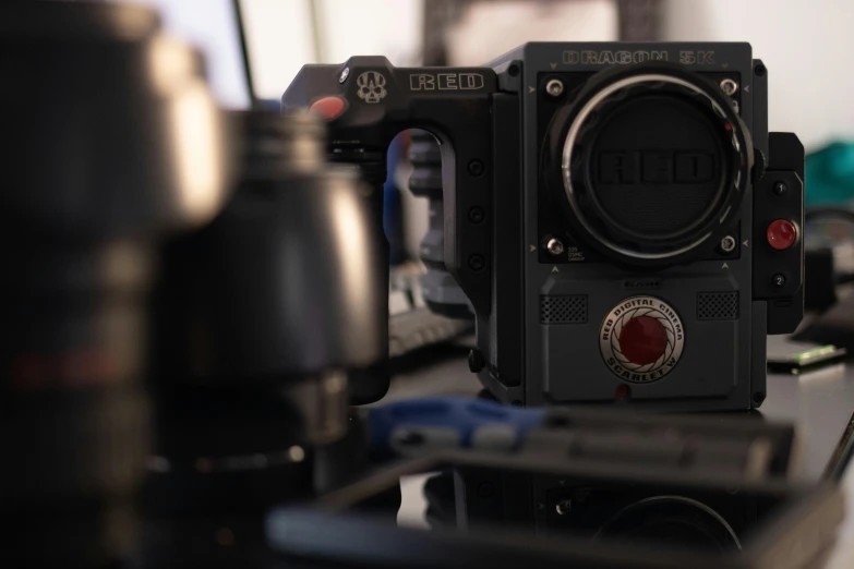 a close up of a camera on a desk, inspired by ridley scott, reddit, red weapon 8 k s 3 5, with unreal engine, alexa mini, full body 8k