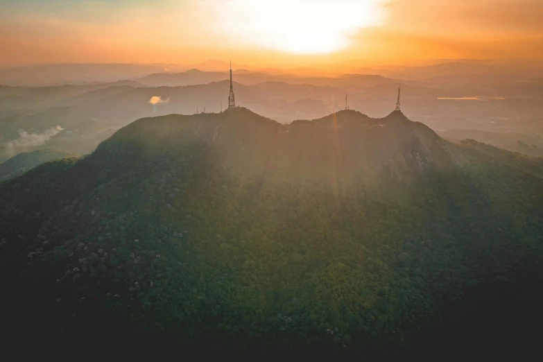 the sun is setting on the top of a mountain, by Adam Marczyński, pexels contest winner, romanticism, aerial footage, sri lankan landscape, 8k octan photo, multiple stories