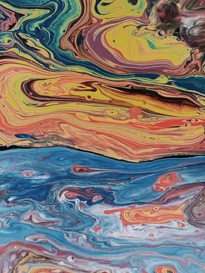 a close up of a painting on a table, inspired by Frederic Church, unsplash, swirling liquids, shoreline, looking happy, /r/earthporn