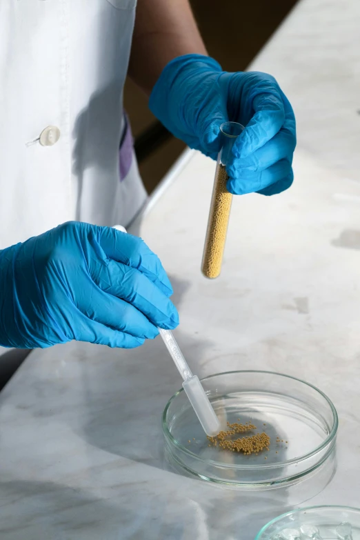 a person in blue gloves is stirring something into a bowl, high samples, crispy quality, thumbnail, formulas