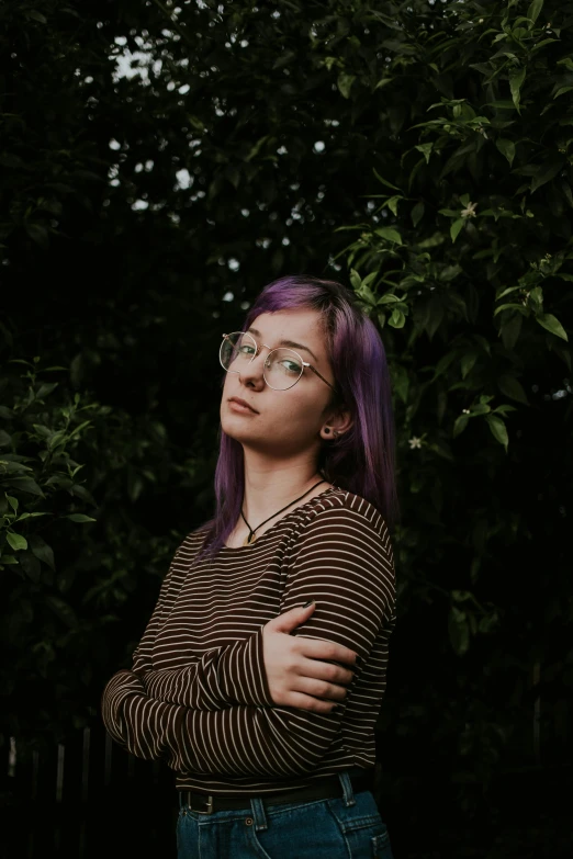 a woman with purple hair standing in front of a tree, inspired by Elsa Bleda, trending on pexels, realism, girl with glasses, thoughtful ), low quality photo, ((portrait))