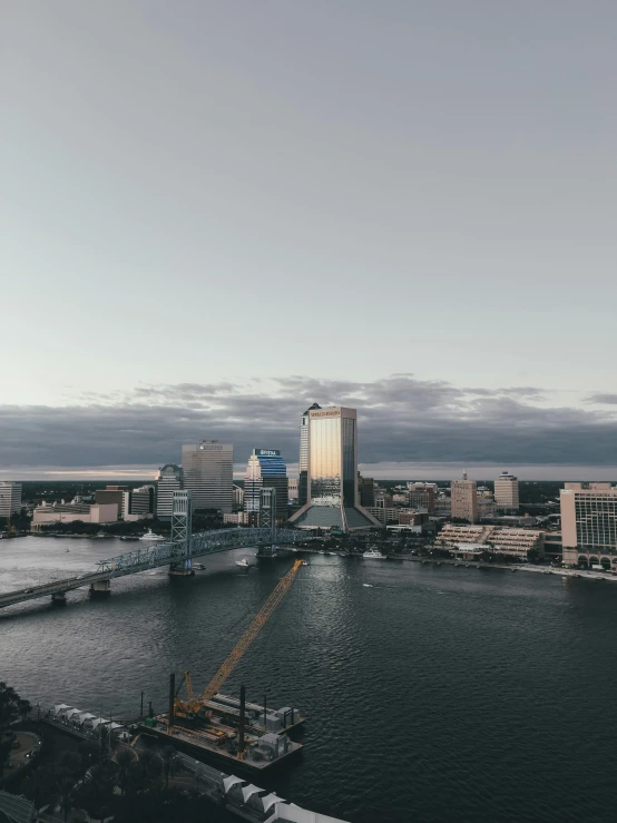 a large body of water next to a city, by Jacob Burck, pexels contest winner, downtown jacksonville florida, slide show, trending on vsco, wide high angle view