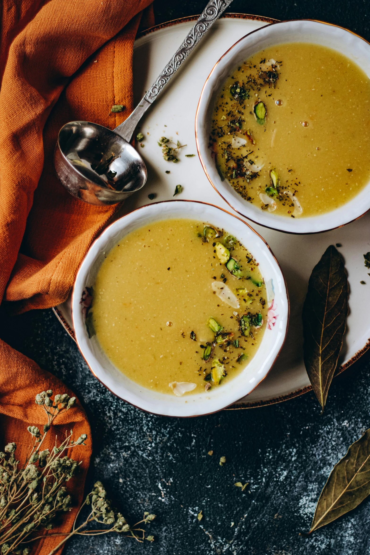 two bowls of soup sitting on top of a plate, by Julia Pishtar, hurufiyya, square, sparkling, mustard, mid fall