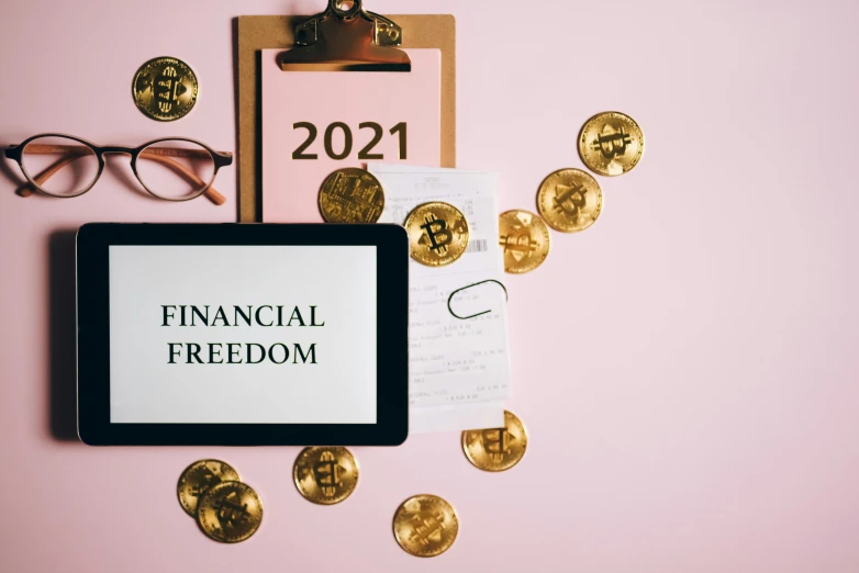 a tablet computer sitting on top of a desk next to coins, by Anna Katharina Block, trending on pexels, sots art, freedom, edible crypto, contest winner 2021, acronym