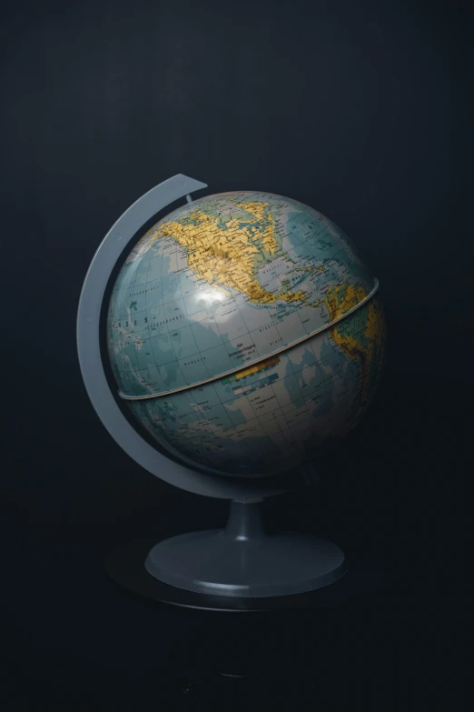 a small globe on a stand against a black background, trending on polycount, hyperrealism, ilustration, paul barson, national geohraphic, world of only concrete