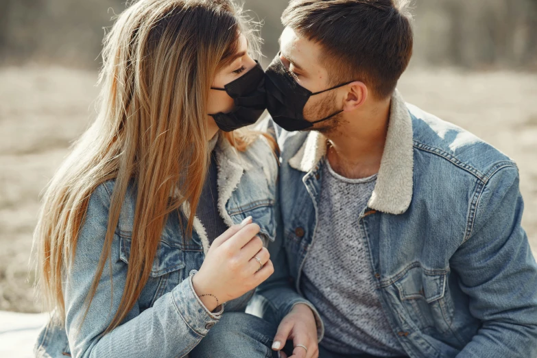 a man and a woman wearing face masks, a picture, by Julia Pishtar, trending on pexels, romanticism, peasant boy and girl first kiss, wearing jeans and a black hoodie, essence, dust mask