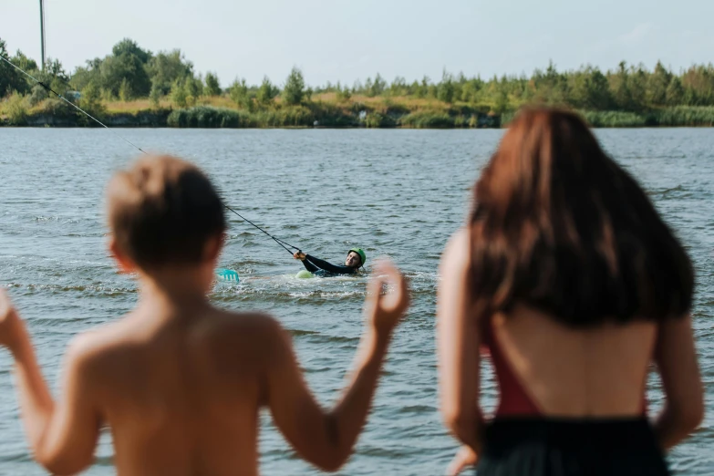 a couple of people that are standing in the water, people swimming, near a lake, petri rahkola, sports photo