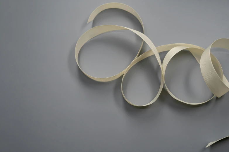 a pair of scissors sitting on top of a piece of paper, an abstract sculpture, inspired by Jan Rustem, unsplash, generative art, carved ivory, obi strip, white sleeves, fully rendered light to shadow