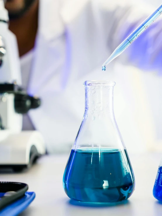 a close up of a person using a microscope, beakers full of liquid, phthalo blue, thumbnail, industries