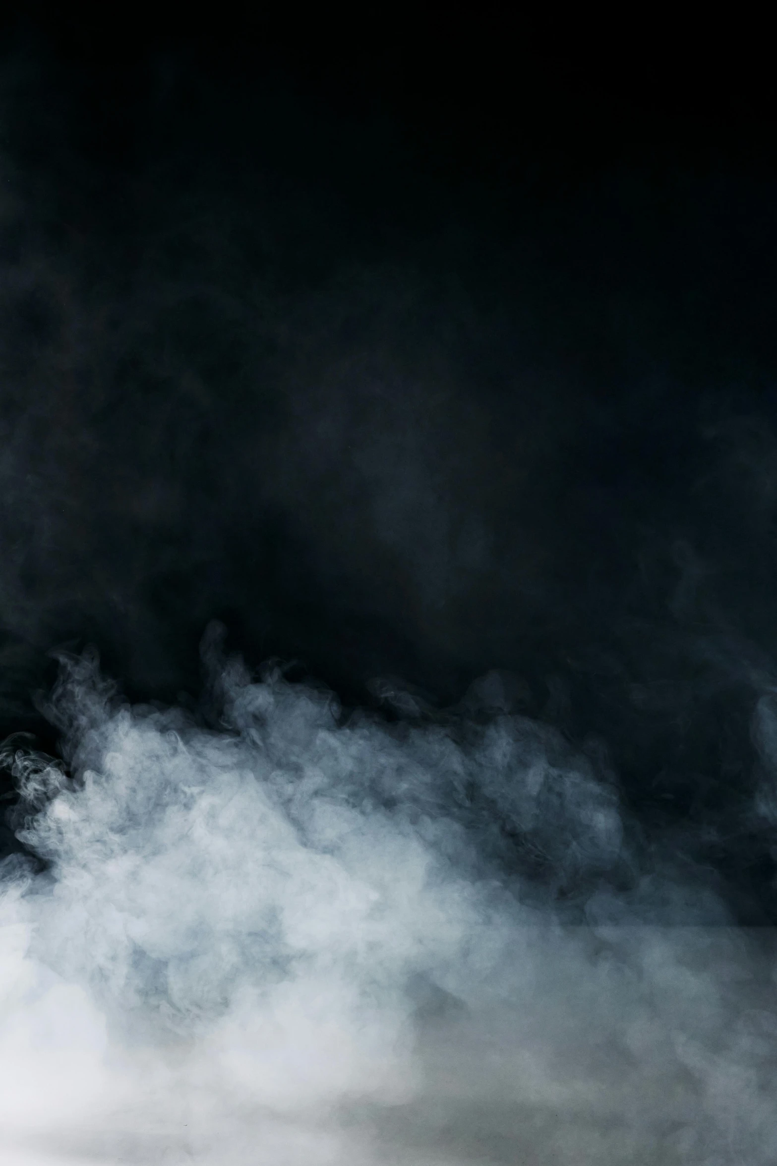 a man riding a snowboard down a snow covered slope, an album cover, by Andries Stock, pexels contest winner, baroque, smoke and volumetric fog, black backdrop, an abstract, background ( smoke