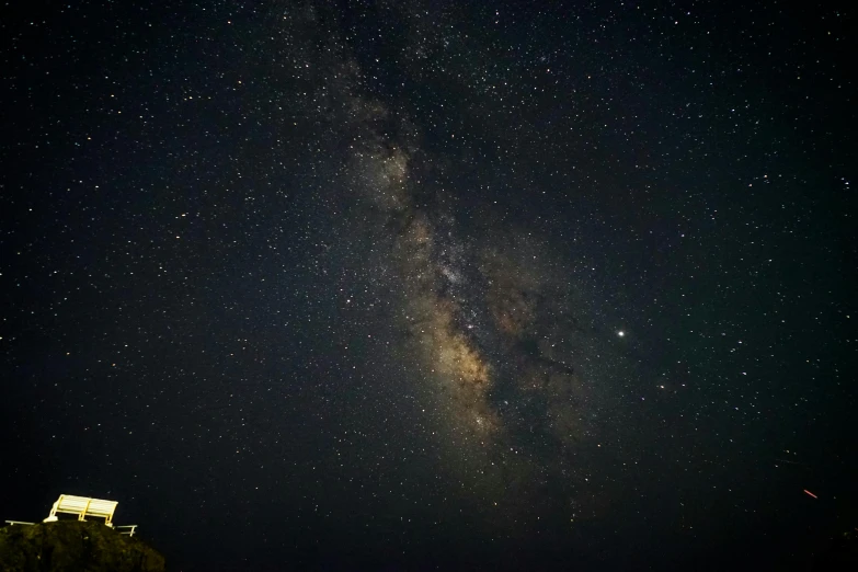 the milky shines brightly in the night sky, a portrait, by Matt Cavotta, pexels, fan favorite, extremely grainy, long