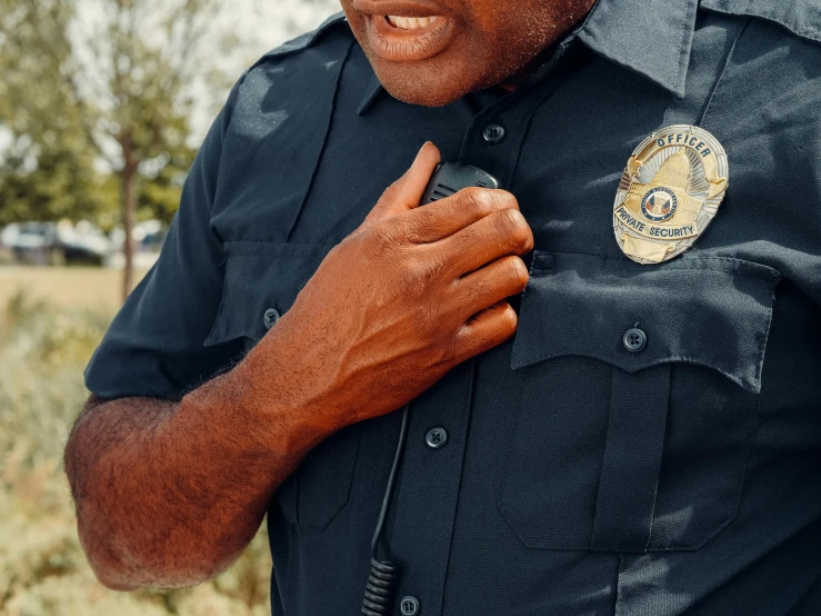 a close up of a person in a uniform, by Carey Morris, trending on pexels, symbolism, handling riffle on chest, compassionate, cop, diverse