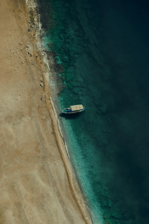 a boat sitting on top of a sandy beach, pexels contest winner, hurufiyya, satellite imagery, red sea, [ cinematic, navy