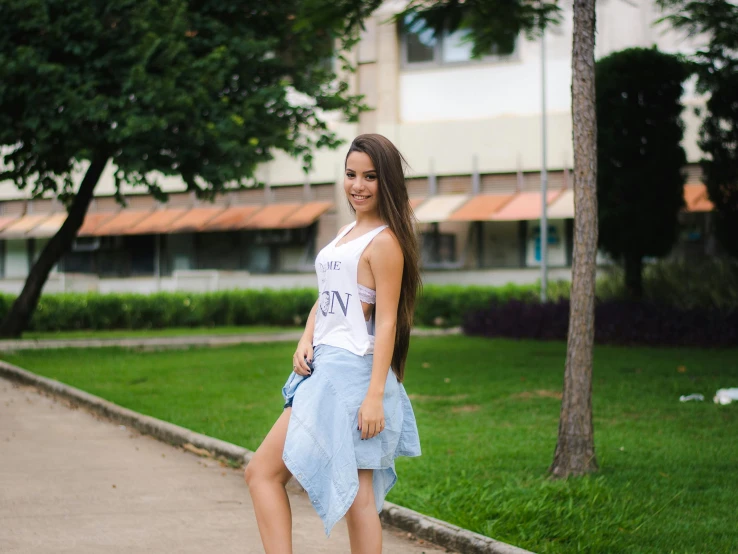 a woman riding a skateboard down a sidewalk, inspired by Gina Pellón, pexels contest winner, wearing a tanktop and skirt, avatar image, brazilan supermodel, posing for a picture