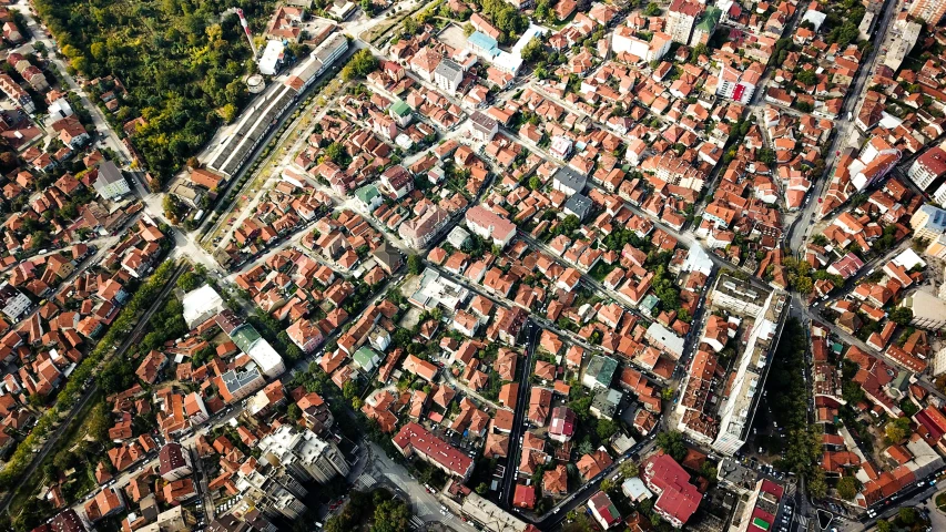 an aerial view of a city with lots of buildings, by Emma Andijewska, pexels, happening, bosnian, high polygon, red roofs, panels