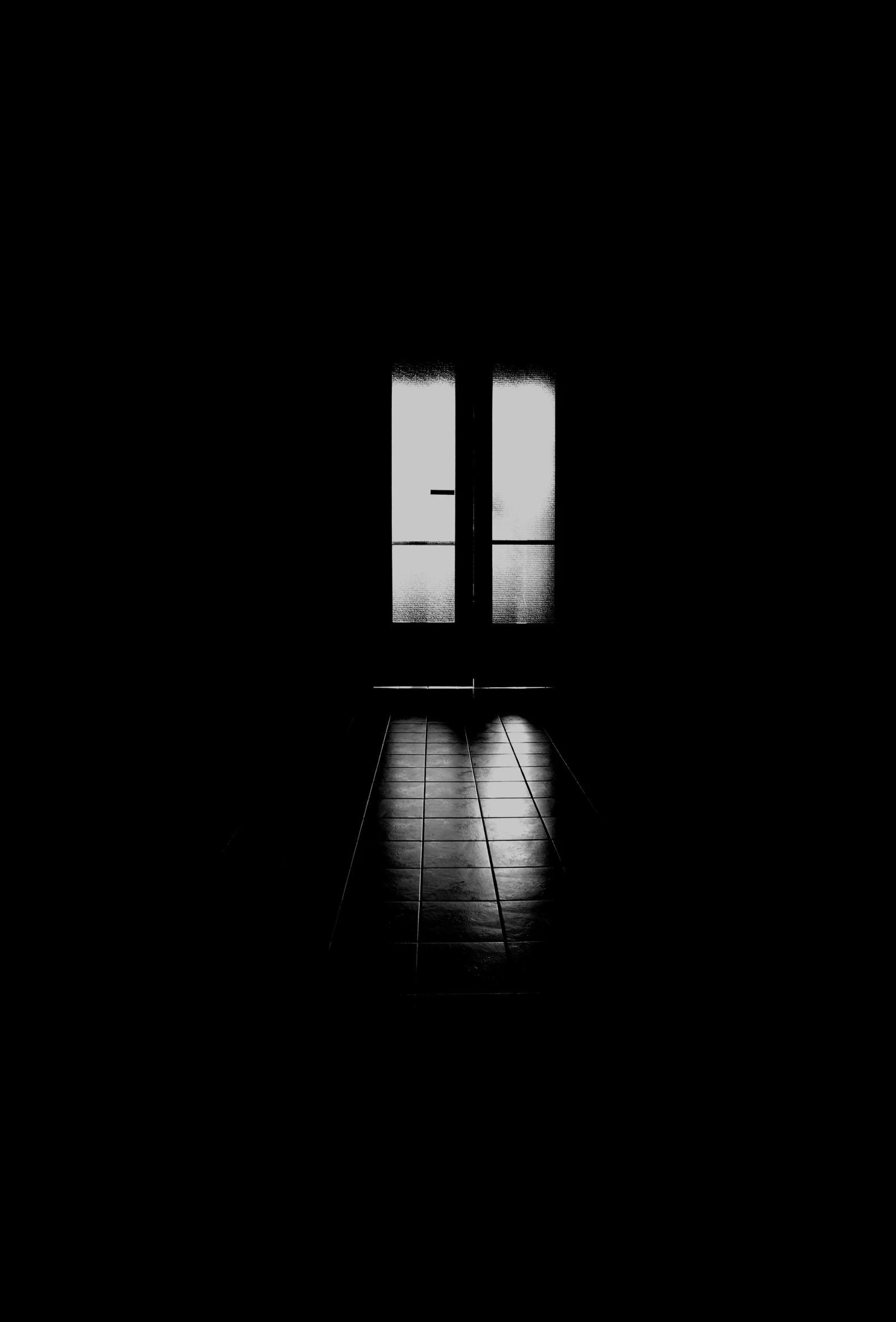 a black and white photo of a door in a dark room, a black and white photo, by Zsolt Bodoni, conceptual art, ffffound, dark ambient album cover, early morning mood, black floor