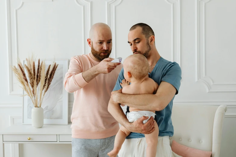 a man brushing a baby's teeth with a toothbrush, a photo, pexels contest winner, antipodeans, two men hugging, avatar image, beskinski, father holds child in the hand