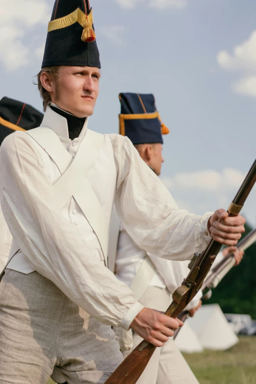 a couple of men standing next to each other holding guns, a colorized photo, by Attila Meszlenyi, pexels contest winner, renaissance, white uniform, on a battle field, thousand yard stare, lots of white cotton