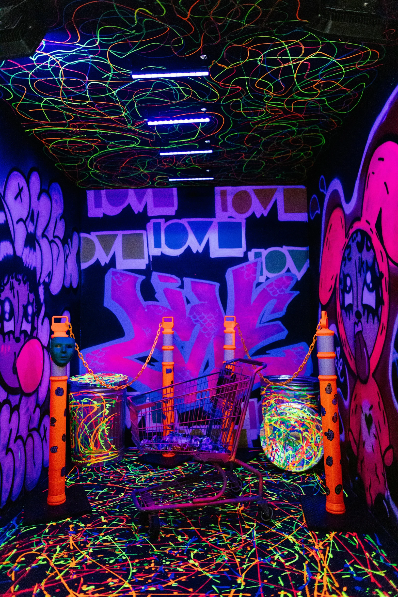 a room with neon lights and graffiti on the walls, glow sticks, love art, a psychedelic experience, lazertag