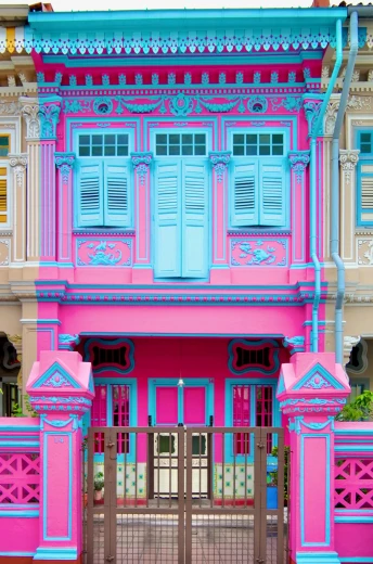 a pink and blue building with blue shutters, singapore city, ornate carved architecture, dayglo pink