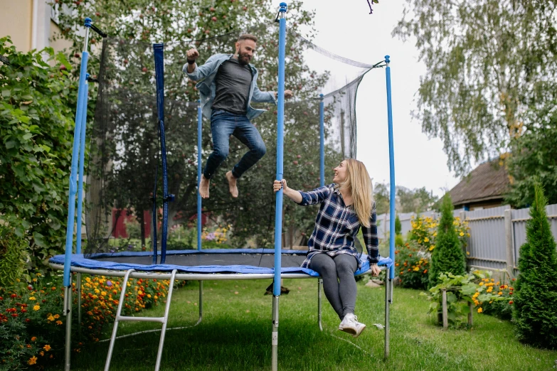 a man and a woman jumping on a trampol, pexels contest winner, figuration libre, in the garden, activity play centre, high quality product image”, very round