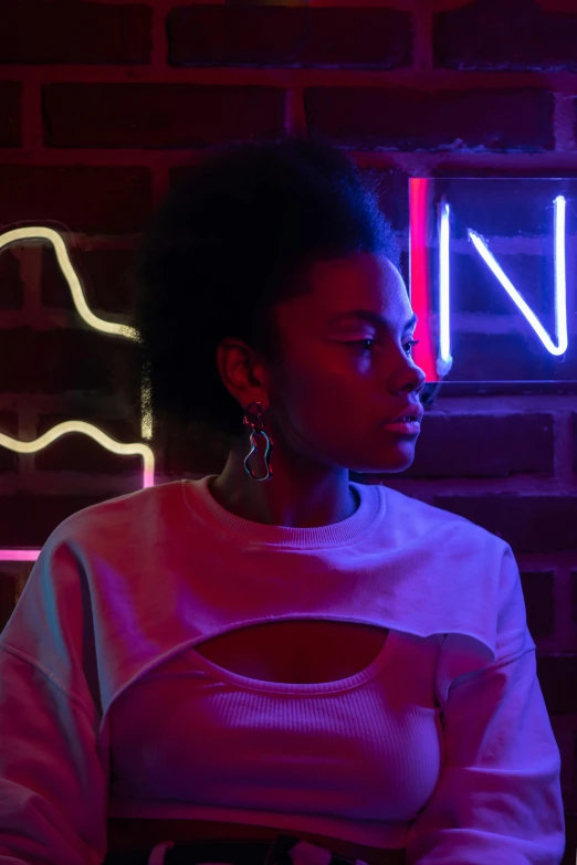 a woman sitting in front of a neon sign, inspired by Nan Goldin, trending on pexels, afrofuturism, black young woman, reflecting light in a nightclub, promotional image, light skin