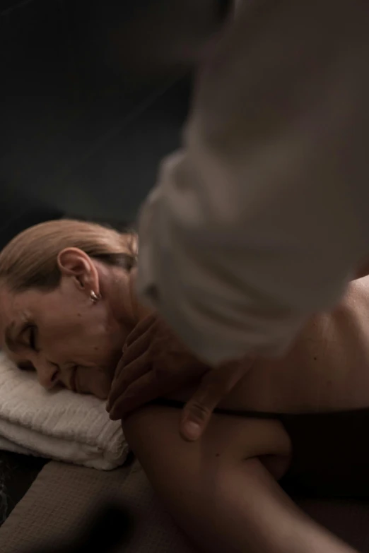 a woman getting a back massage at a spa, by Sam Black, unsplash, massurrealism, low key light, sao paulo, fine art print, cinematic realistic photo