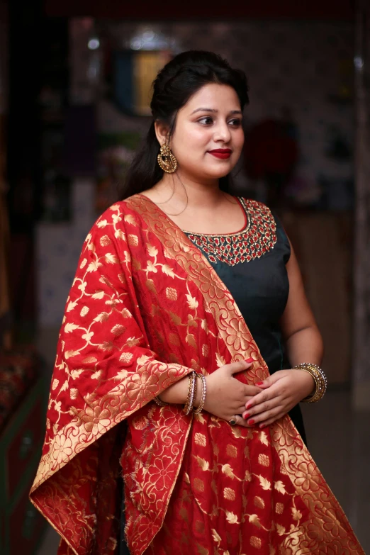 a woman in a red and gold sari, red gold and black outfit, profile image, square, at college