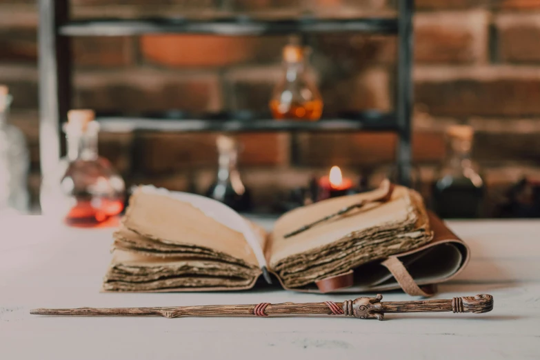 an open book sitting on top of a table, unsplash, private press, potions, holding the elder wand, profile image, retro vibe