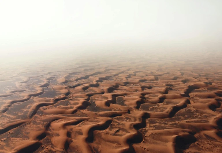 an aerial view of sand dunes in the desert, an album cover, pexels contest winner, floor fog, thirst, humid, arabian